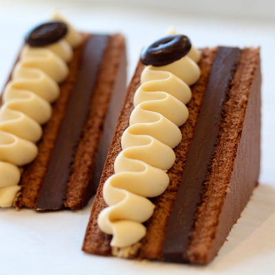 Elegant chocolate and coffee opera cake with layered sponge, ganache, and coffee cream from KNEAD.