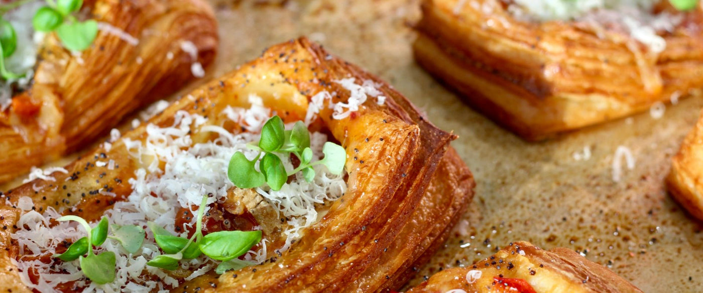 Pastry with cheese and herbs on a baking sheet. Savory Danish pastry. 