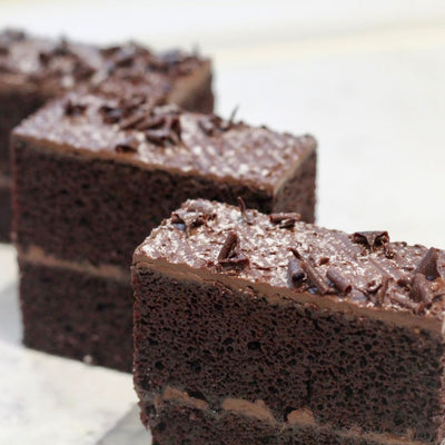 Vegan Black Forest Chocolate Fudge Cake with cherry jam filling and chocolate fudge icing