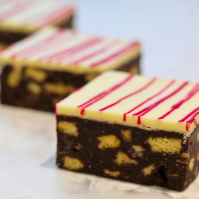 Chocolate tiffin topped with white festive chocolate drizzle