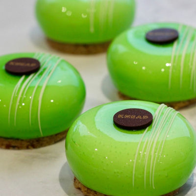 Apple & Hazelnut Mousse on a plate – hazelnut streusel base, apple compote layer, and light mousse on top.