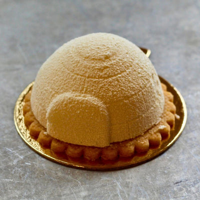 Vanilla Igloo with vanilla cream mousse, white chocolate spray, on a vanilla streusel base